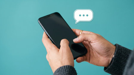 Man using a smartphone with speech bubble on the screen, social media concept