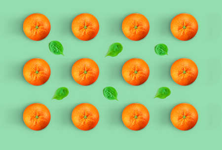 Oranges and spinach leaves pattern.Creative Minimal orange concept. fresh oranges in color...