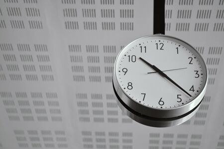 Big White Classic Clock Hanging from the Ceiling