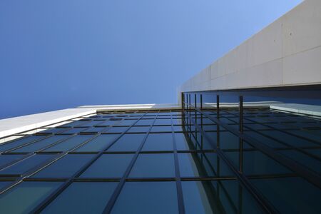 A glass business building with blue sky on the background