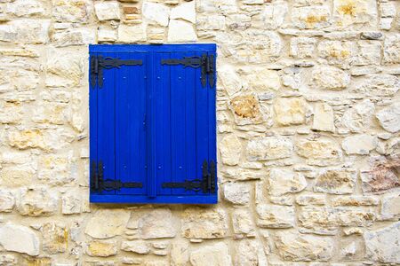 An old rustic blue wooden window in a village in Cyprus