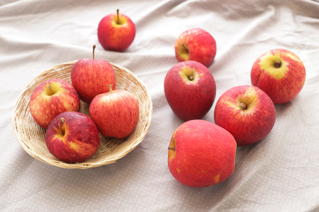 Apples fruit in basket and fabricの写真素材