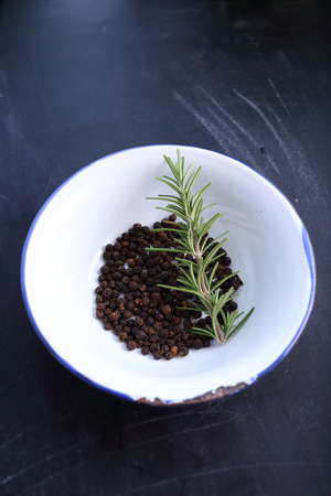 pepper and rosemary in bowlの写真素材