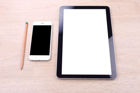 Blank screen smartphone and tablet on wooden backgroundの写真素材