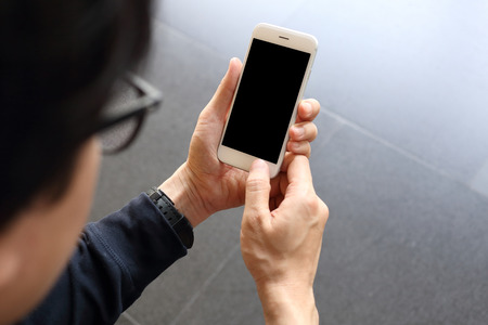 Man hloding and using smartphoneの写真素材
