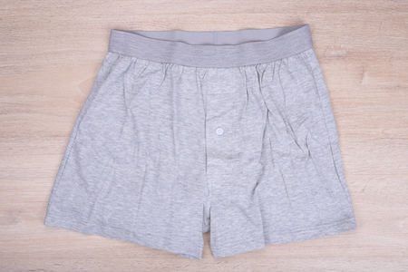 Men gray boxer shorts on wooden backgroundの写真素材