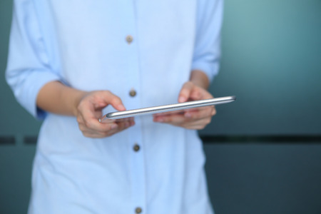 Woman holding with using tablet with office background