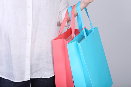 Woman wear white casual shirt with holding shopping bagの写真素材