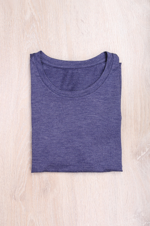 Fold dark blue gray t-shirt on wooden backgroundの写真素材