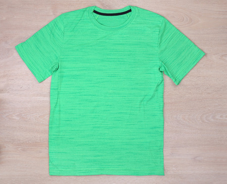 Front view green sport tshirt on wooden backgroundの写真素材