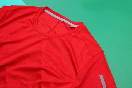 Red running shirt on green color backgroundの写真素材