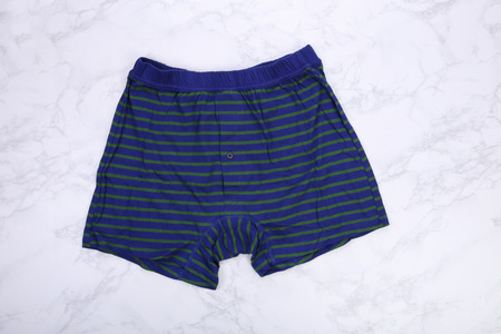 Blue striped green men boxer shorts on white marbleの写真素材