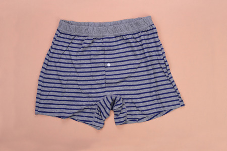 Gray striped blue men boxer shorts on orange pastelの写真素材