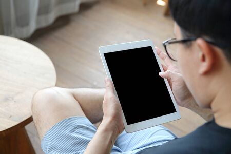 Overhead view business man sit on table with using mockup tablet