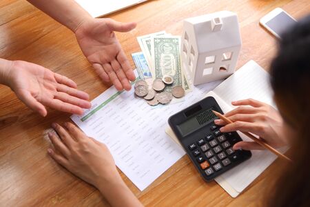 Business peoples discuss with calculate financial data on wooden deskの写真素材