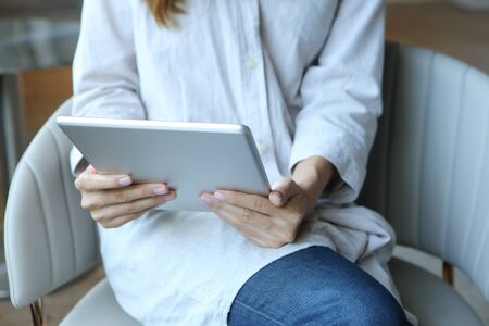 Business woman wear gray shirt with using tablet in coffee shop