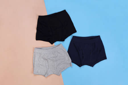 Gray black and navy blue boxer short on pastel floor