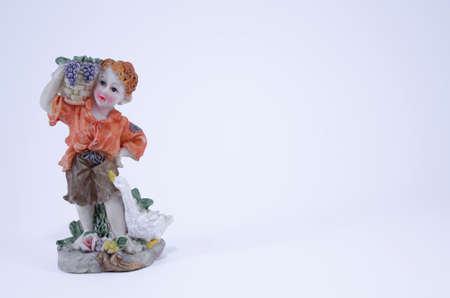 A boy with grape basket ornament isolated on whiteの写真素材