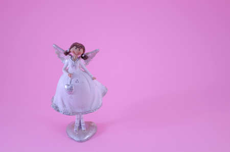 Angel ornament on pinkの写真素材