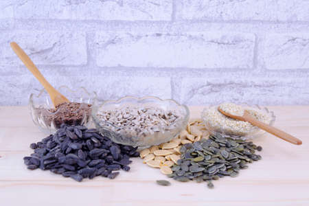 Various pumpkin seeds, sunflower seeds and many other on a tableの写真素材