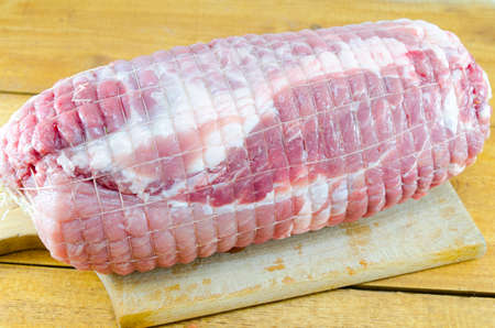 Raw meatloaf on a cutting board ready for roastingの写真素材