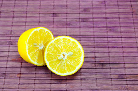 Halved lemons on a bamboo tableの写真素材