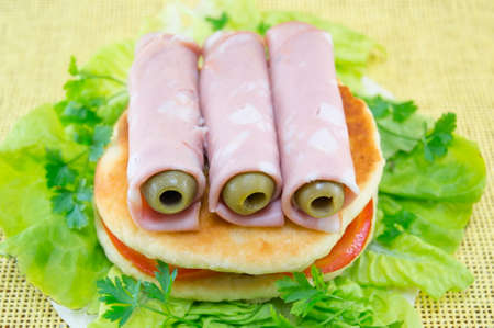 Homemade ham sandwich with olives, tomato and cooked eggsの写真素材