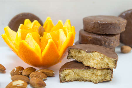 Fluffy chocolate cookies decorated with fresh orange and almondsの写真素材