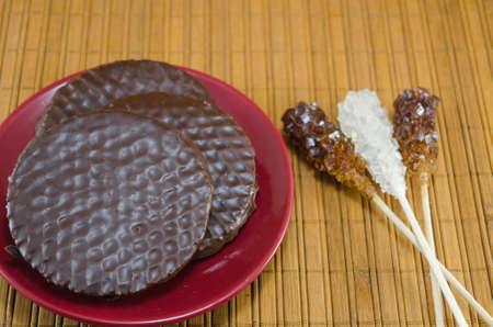 Chocolate biscuits on a red plateの写真素材