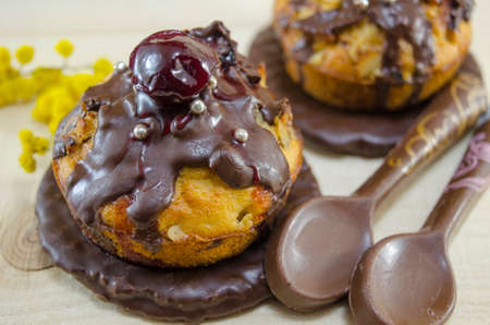 Homemade donuts glazed with chocolate with a cherry on topの写真素材