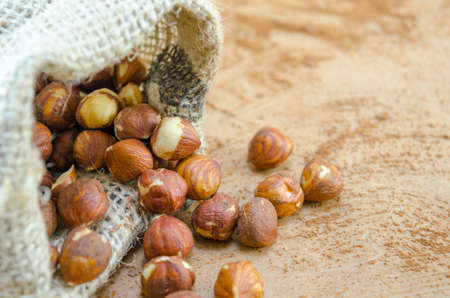 Bunch of Hazelnuts in a vintage bag on a wooden tableの写真素材