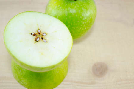 Apple sliced in thin pieces on a wooden tableの写真素材