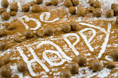 Chocolate balls on a table with the word Happyの写真素材