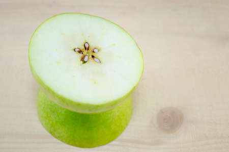 Apple sliced in thin pieces on a wooden tableの写真素材
