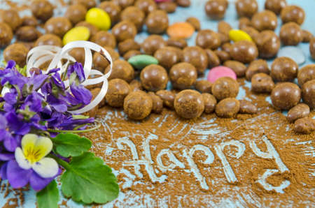 Chocolate balls on a table with the word Happyの写真素材