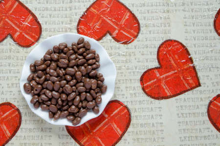 Small chocolates balls in a plate on a decoupage table