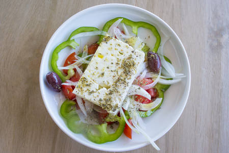 Greek vegetable salad on the table offset