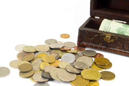 Metal coins with banknotes stashed in the box isolatedの写真素材