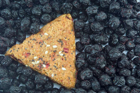 Integral cookie filled with fruit and sesame surrounded with dried aroniaの写真素材