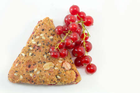 Integral biscuits with currant and red berry fruit isolated with fresh currant fruitの写真素材