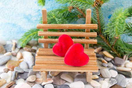 Scene set with two hearts on a miniature wooden benchの写真素材