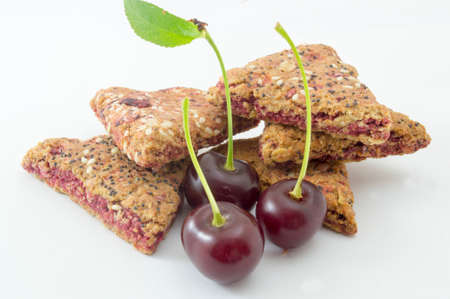 Integral cherry cookies with fresh cherry fruit  on whiteの写真素材