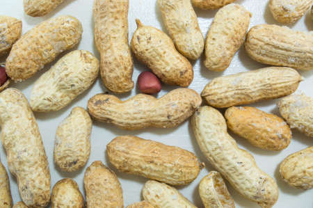 Baked peanuts in shells on the white background