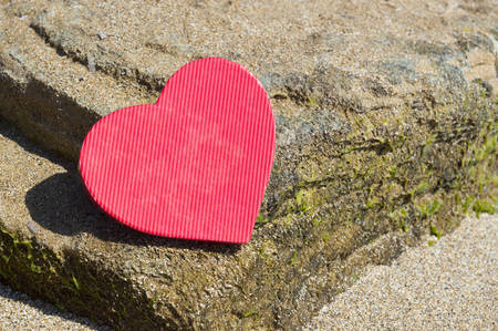 Heart shape placed  on a rocky beach. Summer love abstractの写真素材