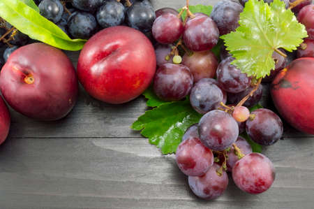 Various summer fruit on the dark wooden table. Healthy fruit backgroundの写真素材