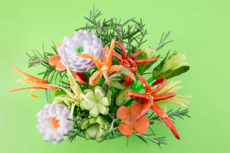 Homemade unique flower shaped vegetables salad on green backgroundの写真素材