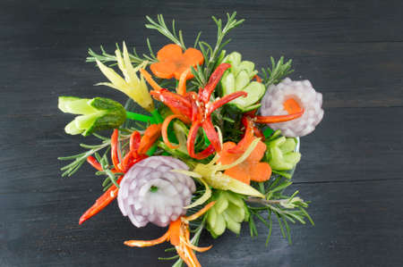 Homemade unique flower shaped vegetables salad on dark backgroundの写真素材