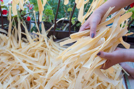 Homemade pasta in woman hands. Pasta production processの写真素材
