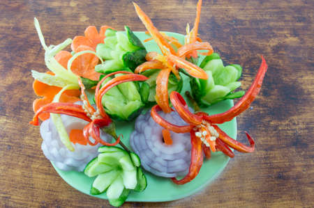 Homemade unique flower shaped vegetables on a wooden tableの写真素材