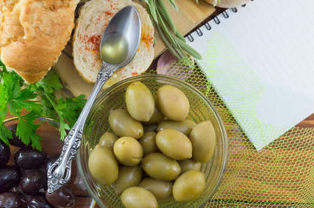 Vegetarian snack. Olives and bread on the tableの写真素材